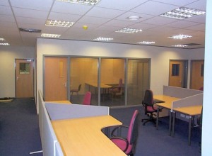 Open-plan office space with desk screens