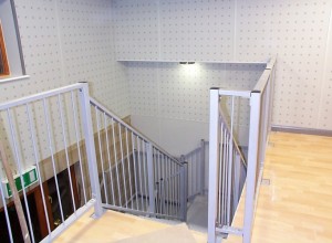 View from mezzanine of staircase , drylining and concealed bulkhead lighting