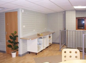 Suspended ceiling and doorway to consumables storage cupboard on mezzanine